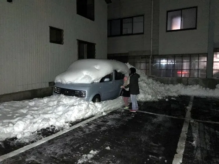 A car covered in snow outside our hotel